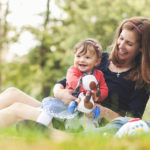 Happy parents with children outdoors having a good family time